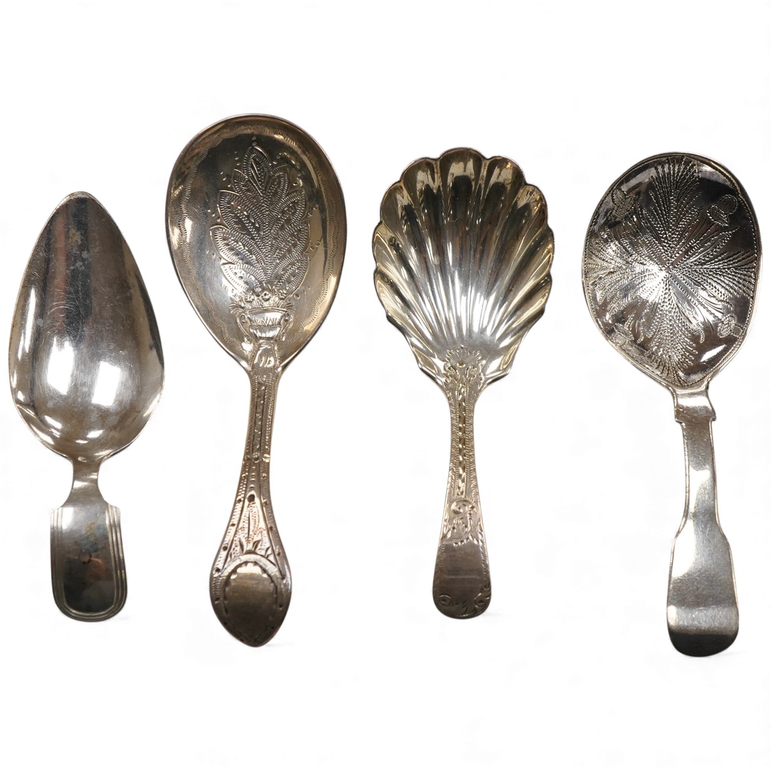 A George IV silver fiddle pattern caddy spoon, the bowl engraved with thistles, James Beebe, London, 1825, 90mm, a Georgian siler caddy spoon, the bowl embossed with urn and flowers, a late Victorian silver caddy spoon w